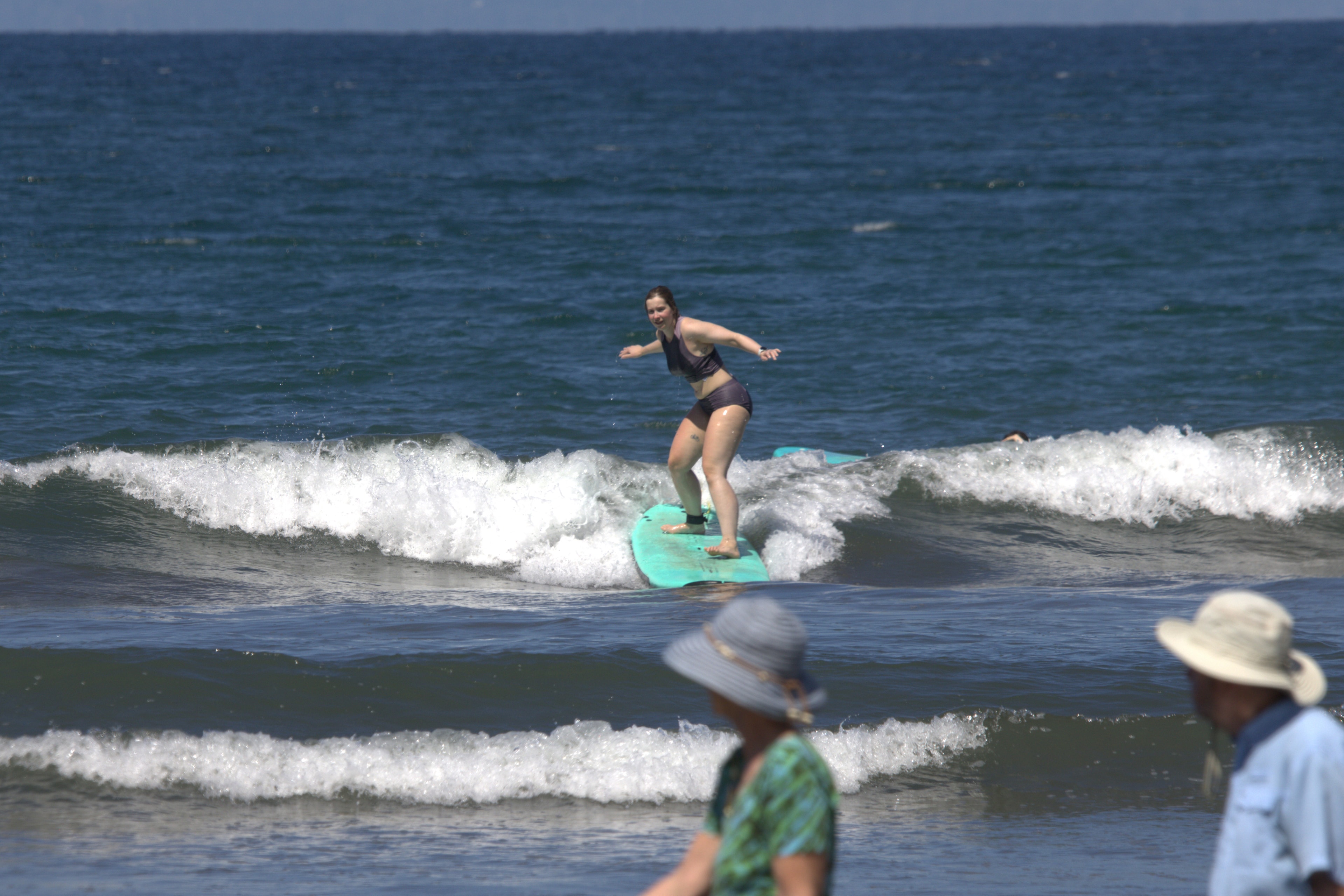 Intermediate surfer riding a wave at Playa Hermosa